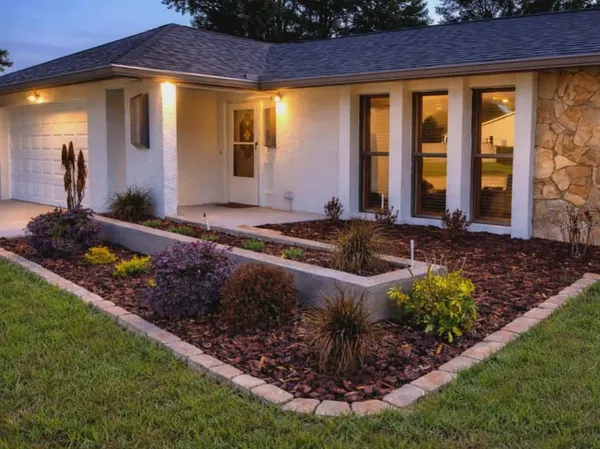 a front view of a house with garden