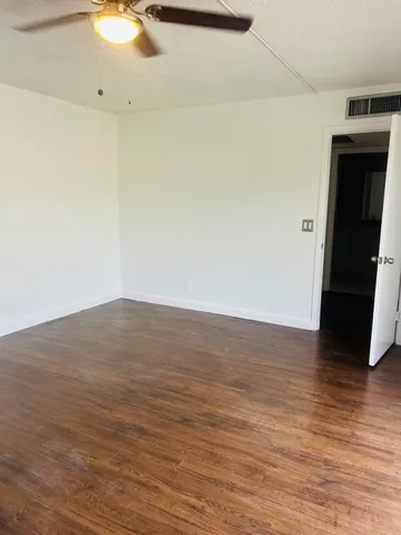 a view of a room with wooden floor