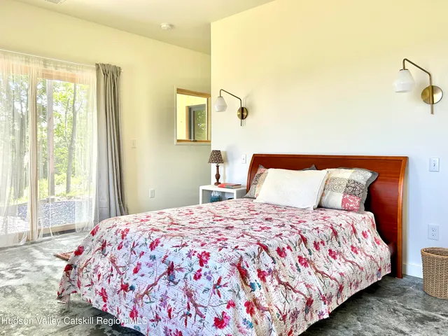 a bedroom with a large bed and a window