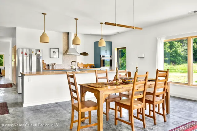 a dining area with furniture a chandelier and window