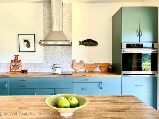a kitchen with a sink a stove and cabinets