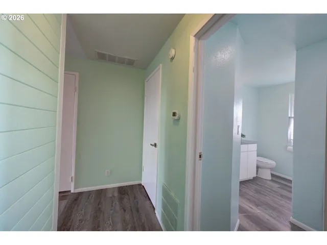 a bathroom with a granite countertop sink a toilet and mirror