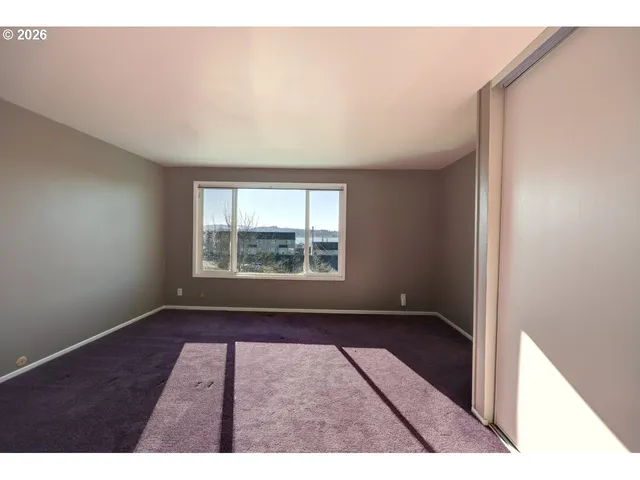 a view of a bedroom with washer and dryer