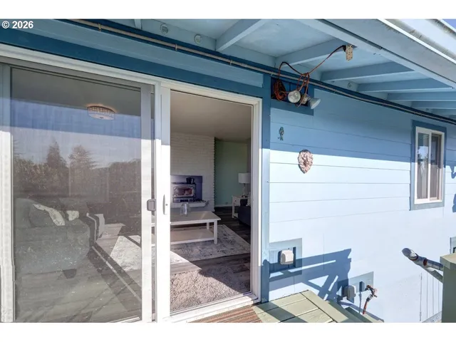 a backyard of a house with table and chairs