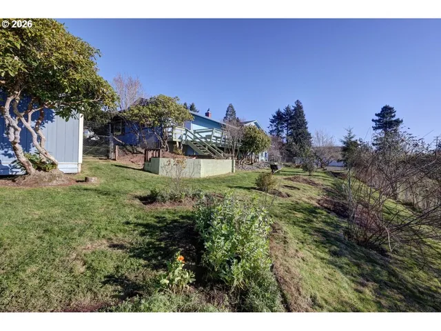 a backyard of a house with lots of green space and a fountain