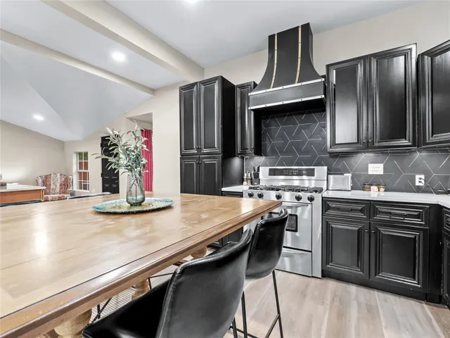 a kitchen with stainless steel appliances granite countertop a stove and a sink