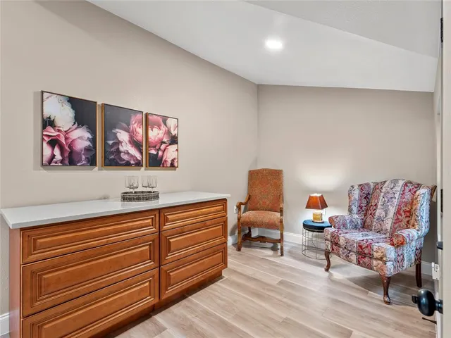 a living room with furniture and painting on the wall