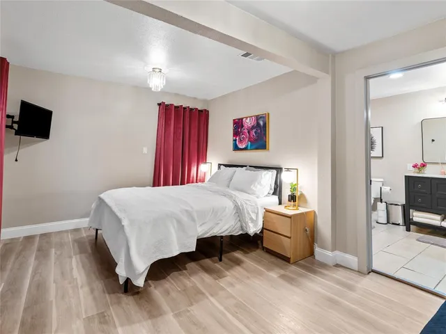 a bedroom with a bed and a flat screen tv