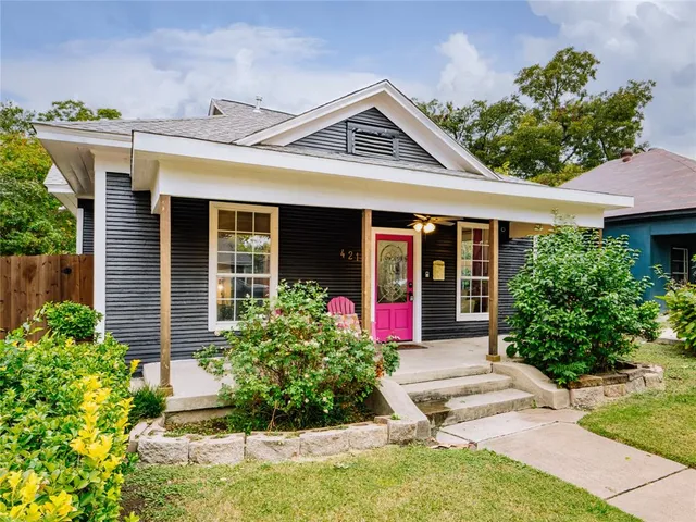 front view of a house with potted plants