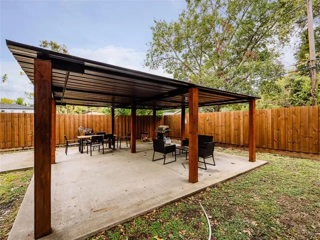 a backyard of a house with table and chairs