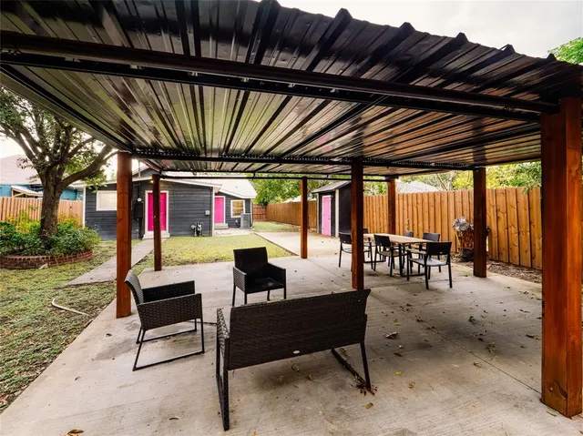 a outdoor living space with furniture and a fireplace