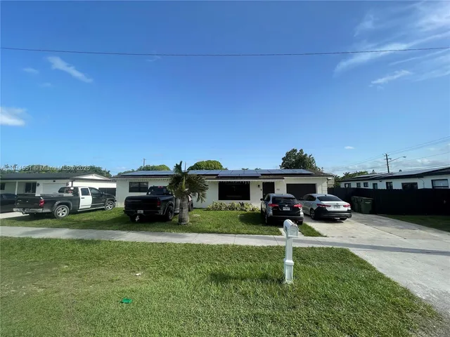a view of a house with swimming pool and sitting area