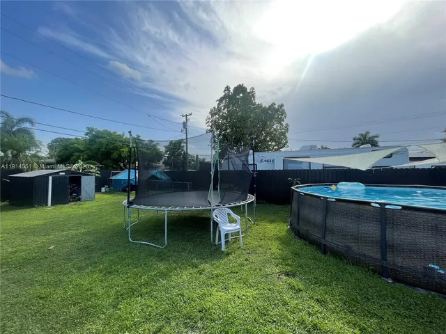 a view of a backyard with sitting area
