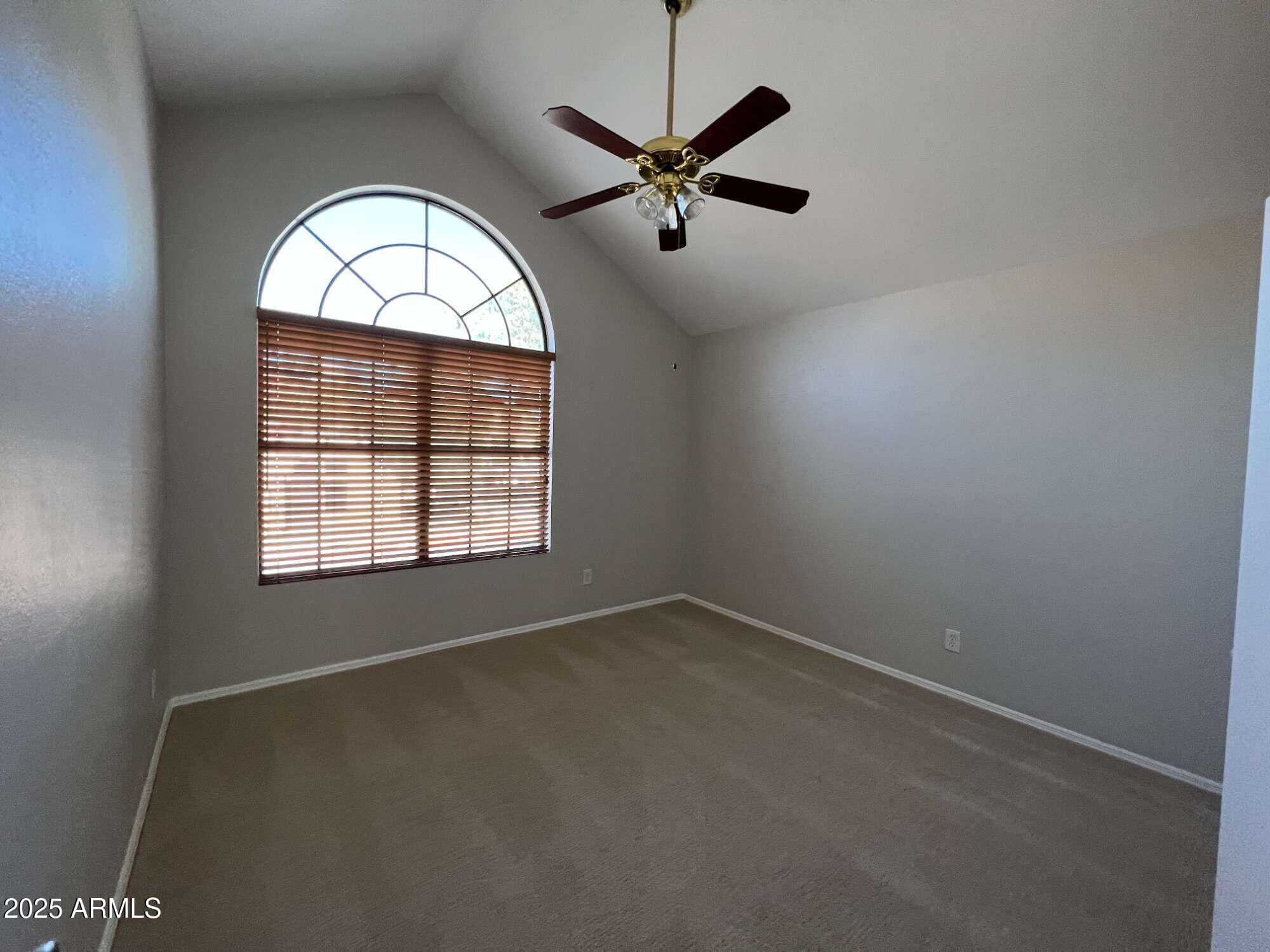 5704 East Aire Libre Avenue, Unit 1081 Scottsdale, AZ 85254 - Photo 15 of 18 an empty room with ceiling fan and window