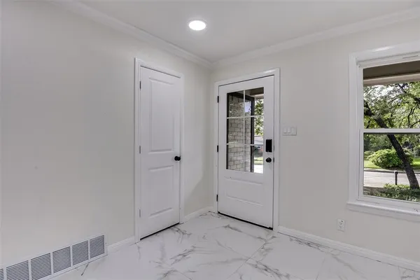 an empty room with windows and closet