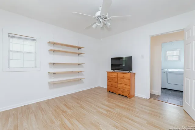 a view of a bedroom with wooden floor and closet