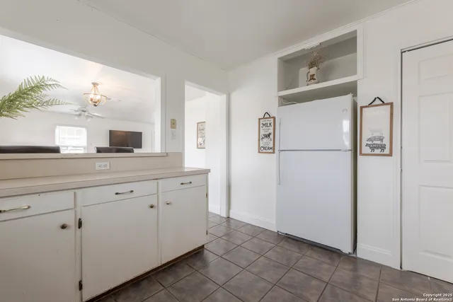 a kitchen with a refrigerator and a sink