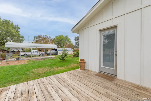 a view of house with garden space and deck