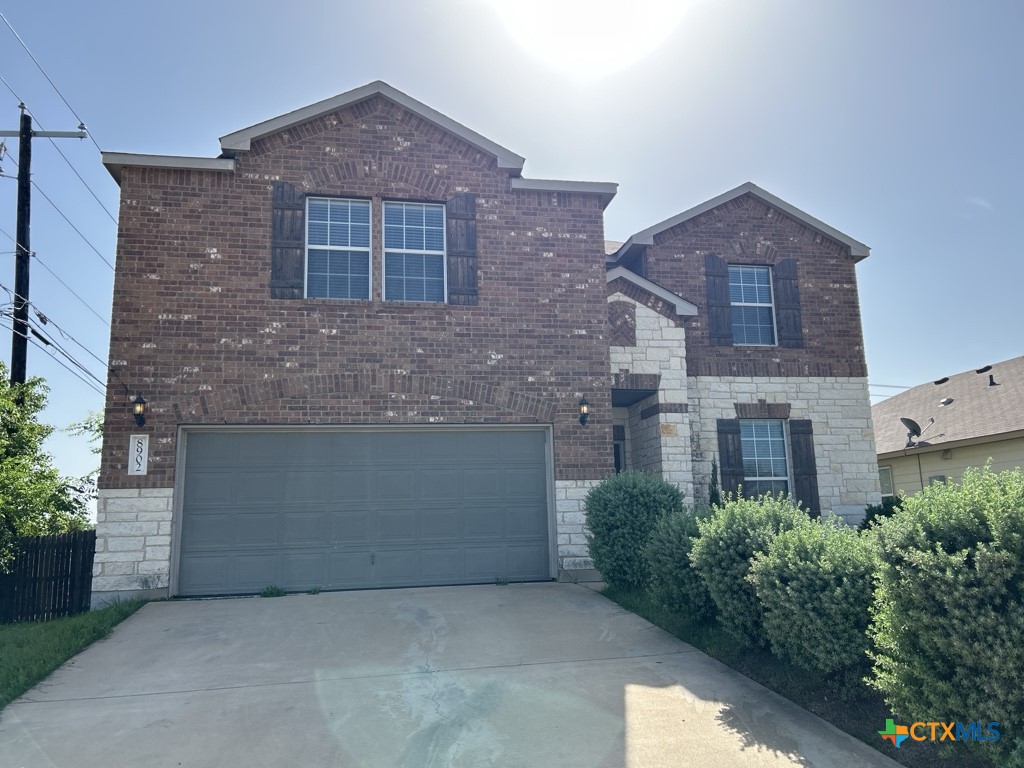 8902 Bowfield Drive Killeen, TX 76542 - Photo 1 of 1 a front view of a house with yard and plants