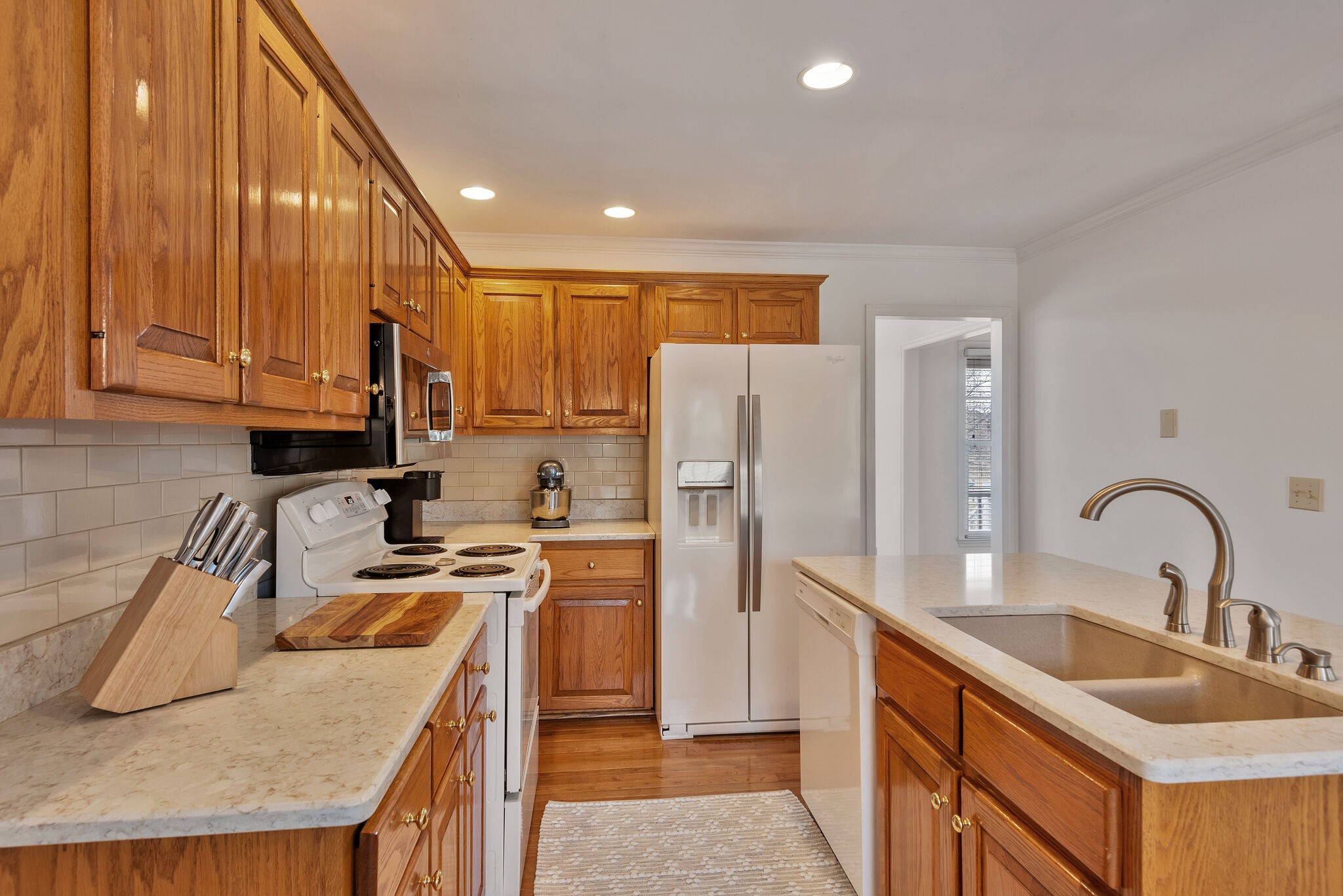 1102 High Lake Drive Dickson, TN 37055 - Photo 14 of 50 a kitchen with kitchen island granite countertop a sink a counter space appliances and cabinets