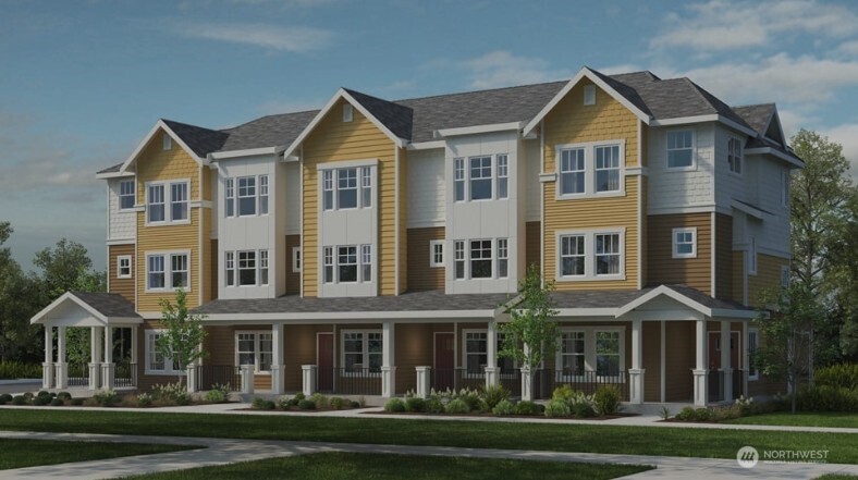 a front view of a residential apartment building with a yard