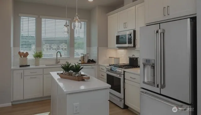a bathroom with a double vanity sink mirror and shower
