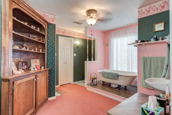 a living room with furniture and a mirror