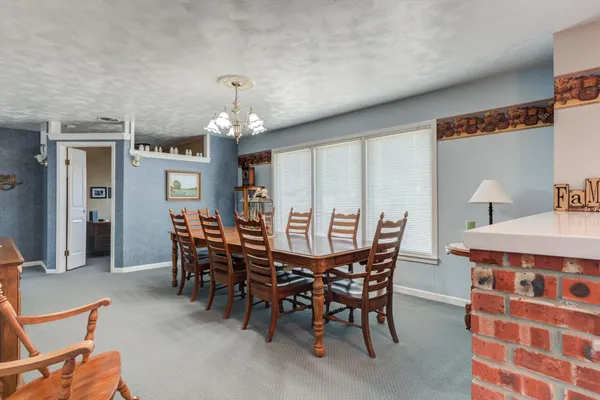 a view of a dining room with furniture and chandelier