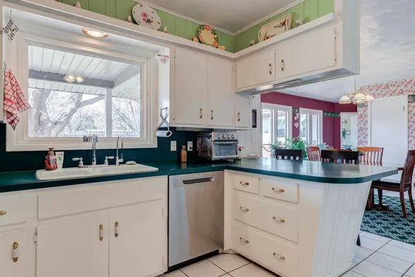a kitchen with granite countertop a sink and cabinets