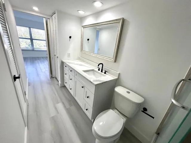 a white toilet sitting next to a bathroom sink