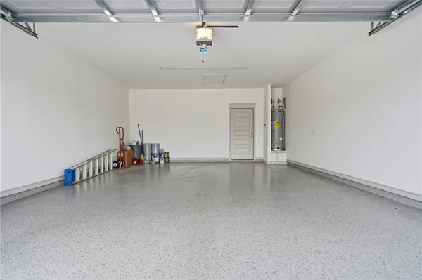 an empty room with ceiling fan and windows