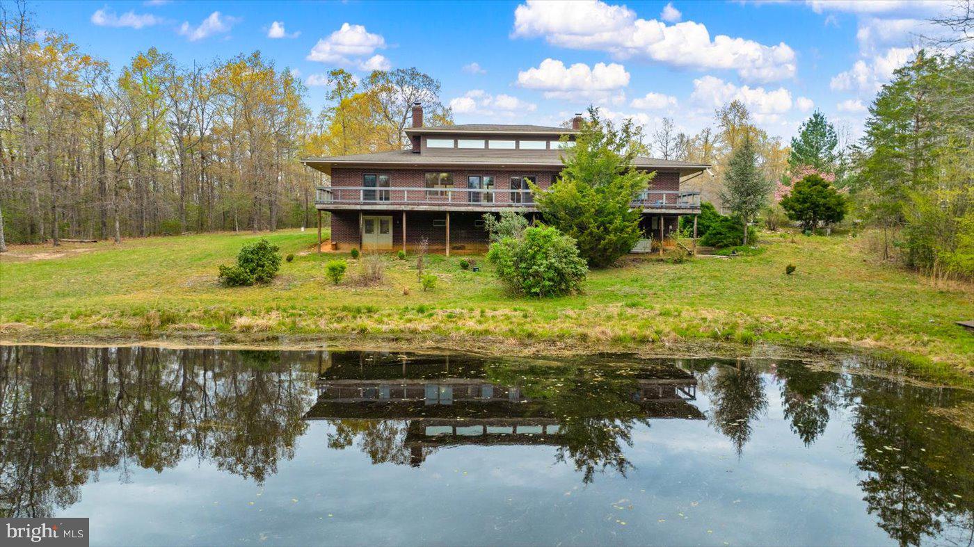 29227 General Rhodes Lane Rhoadesville, VA 22542 - Photo 69 of 129 a view of a swimming pool with a patio and a yard with lake view