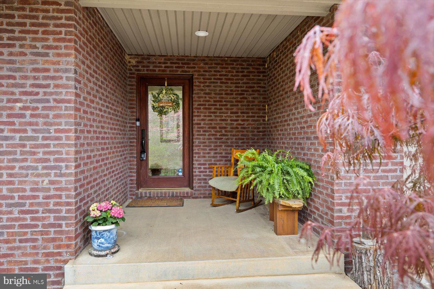29227 General Rhodes Lane Rhoadesville, VA 22542 - Photo 77 of 129 a potted plant sitting on the side of a brick wall