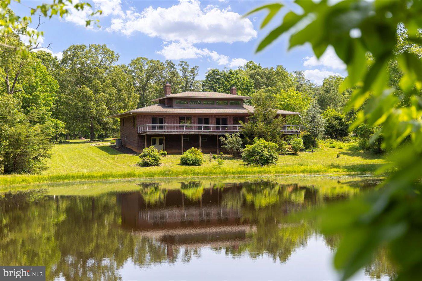 29227 General Rhodes Lane Rhoadesville, VA 22542 - Photo 92 of 129 a view of a lake with a house in the background