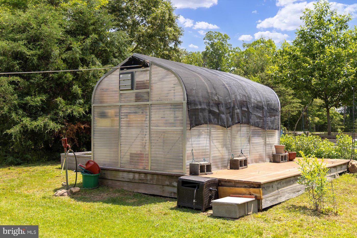 29227 General Rhodes Lane Rhoadesville, VA 22542 - Photo 100 of 129 a front view of a house with swimming pool and sitting area