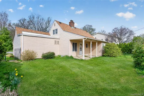 a view of a house with a yard and plants