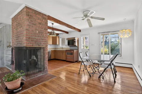 a workspace with wooden floor a fireplace a potted plant and a fireplace