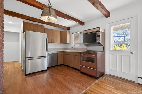 a kitchen with a refrigerator and a stove top oven