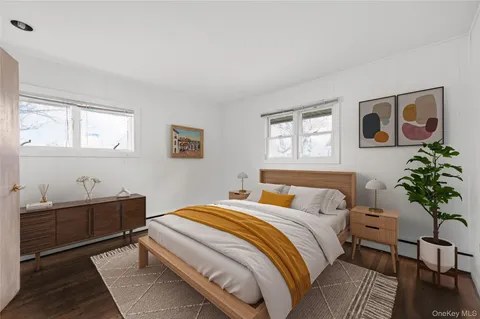 a bedroom with a bed and a potted plant