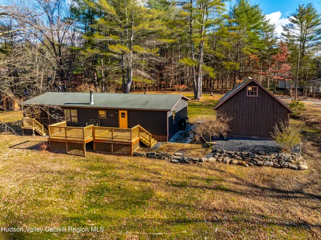 a view of a house with large trees