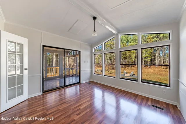 a kitchen with granite countertop a refrigerator and cabinets