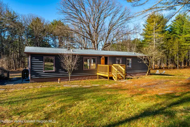 a view of a house with pool and sitting area