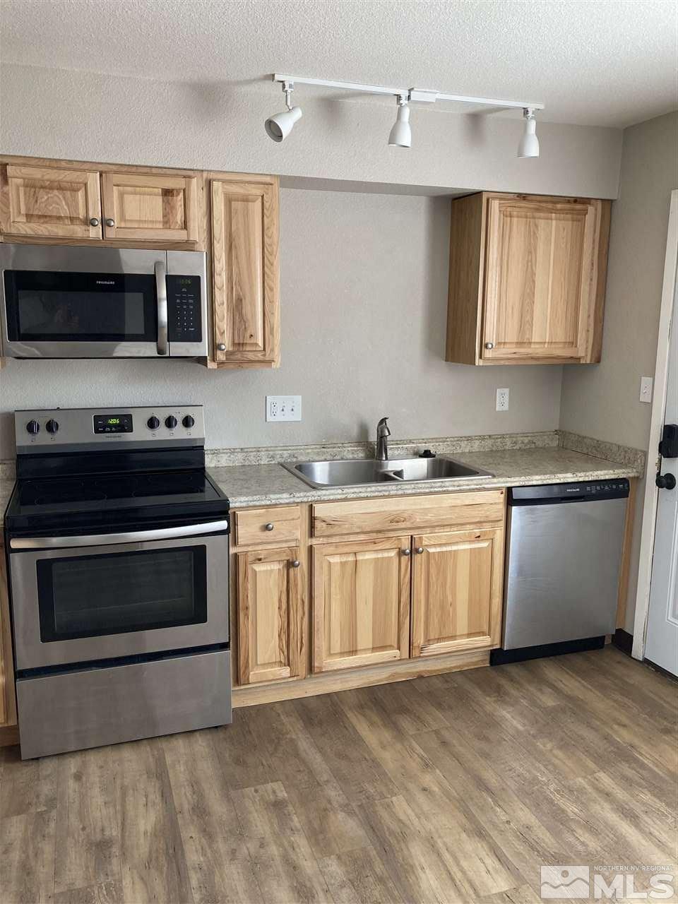 1402 East 9th Street, Unit 6 Reno, NV 89512 - Photo 3 of 10 a kitchen with stainless steel appliances a stove sink and cabinets