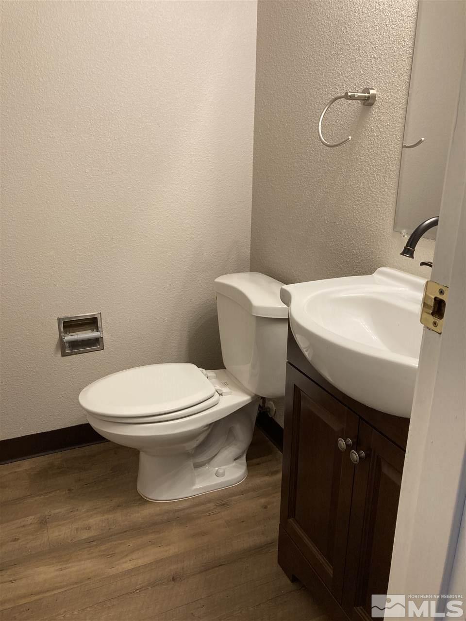 1402 East 9th Street, Unit 6 Reno, NV 89512 - Photo 6 of 10 a white toilet sitting next to a bathroom sink