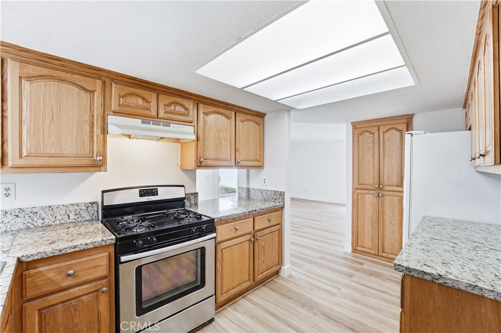 338 Mildred Street Perris, CA 92571 - Photo 12 of 34 a kitchen with stainless steel appliances granite countertop a stove and a sink