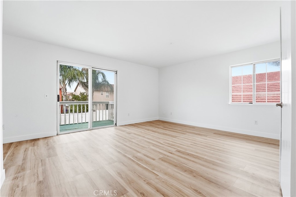 338 Mildred Street Perris, CA 92571 - Photo 16 of 34 a view of an empty room with wooden floor and a window