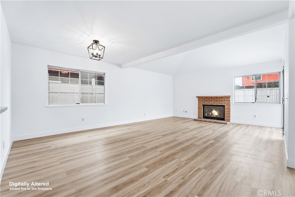 338 Mildred Street Perris, CA 92571 - Photo 8 of 34 an empty room with windows and fireplace