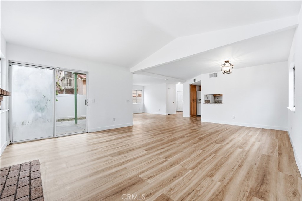 338 Mildred Street Perris, CA 92571 - Photo 9 of 34 an empty room with wooden floor and windows