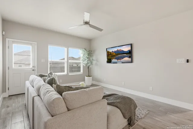 a living room with furniture and a large window