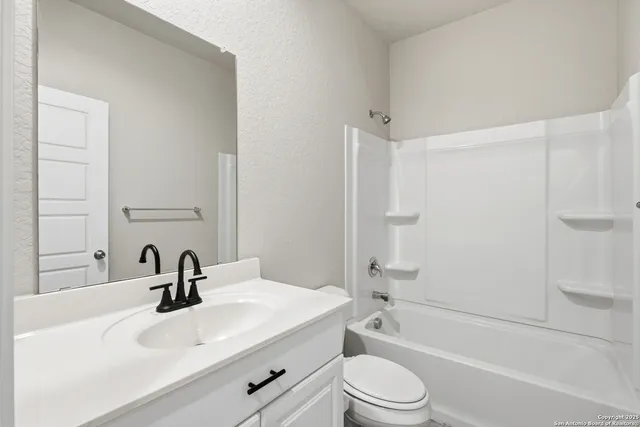 a bathroom with a sink a toilet and a bathtub